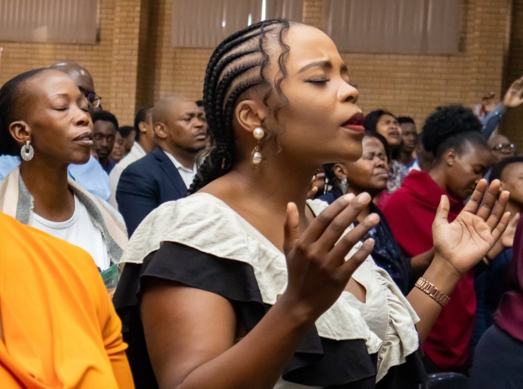 Congregation worshipping together in prayer